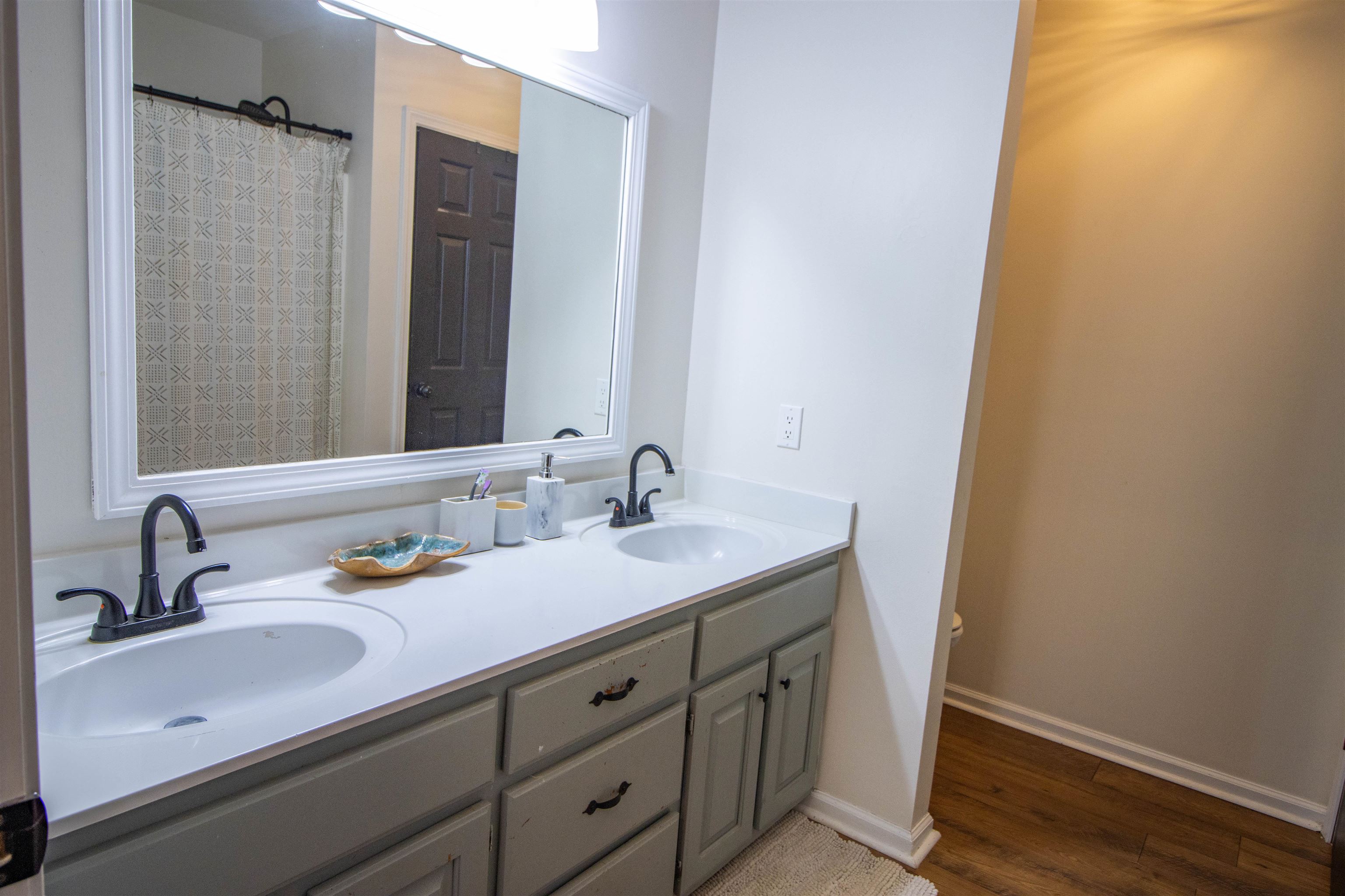 120 Craig Road Ripley, TN 38063 - Photo 17 of 38 Dual vanity with undermount sinks, matte black fixtures, and a white framed mirror
