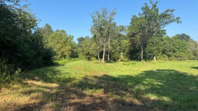 a view of water with a yard