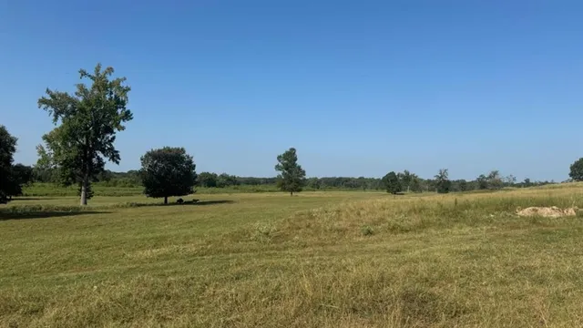 a view of a house with a porch and a yard