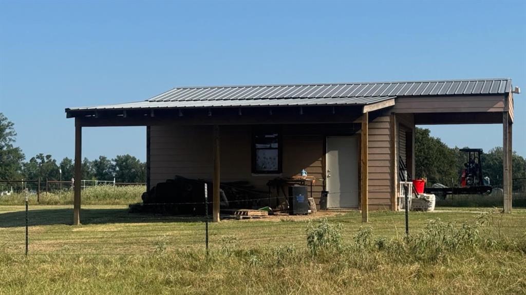 768 County Road 2220 Talco, TX 75487 - Photo 27 of 40 a view of a house with a porch and a yard