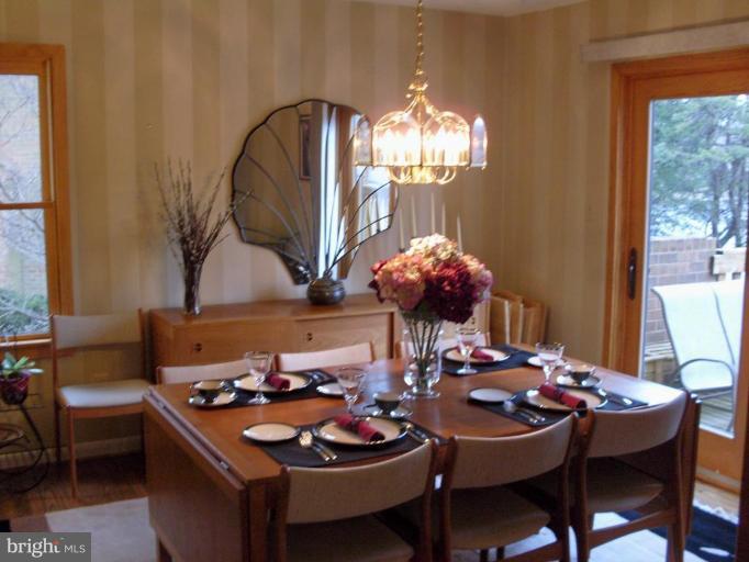 11082 Thrush Ridge Road Reston, VA 20191 - Photo 5 of 14 a dining room with furniture a chandelier and window