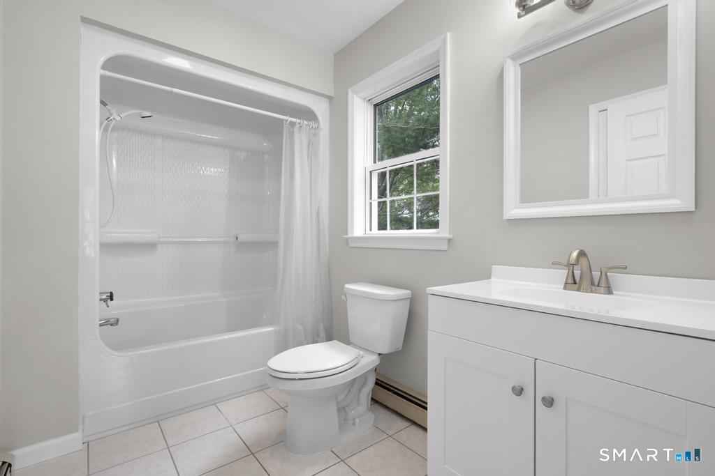 815 South Pine Creek Road Fairfield, CT 06824 - Photo 18 of 32 a bathroom with a sink a toilet and shower