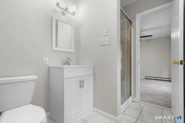 a bathroom with a toilet a sink and mirror