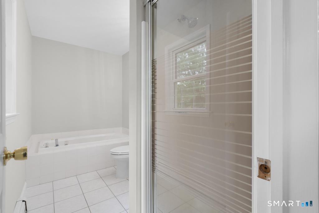 815 South Pine Creek Road Fairfield, CT 06824 - Photo 22 of 32 a bathroom with a bathtub and toilet