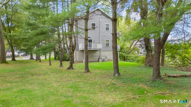 a house view with a garden and trees