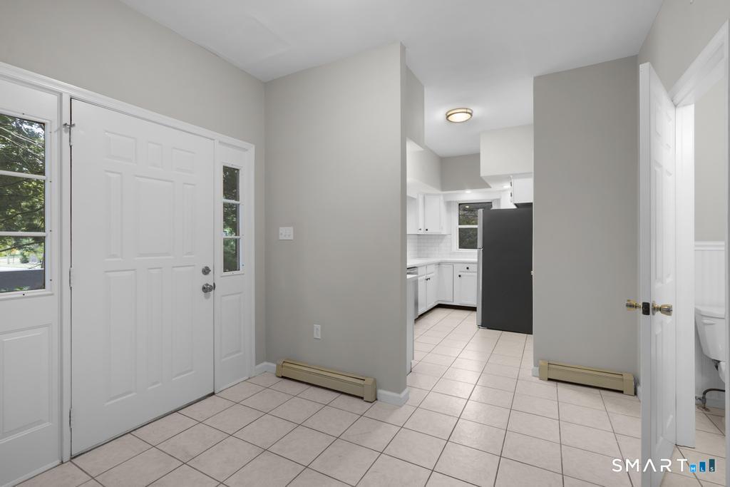 815 South Pine Creek Road Fairfield, CT 06824 - Photo 4 of 32 a view of a refrigerator and mirror in a room