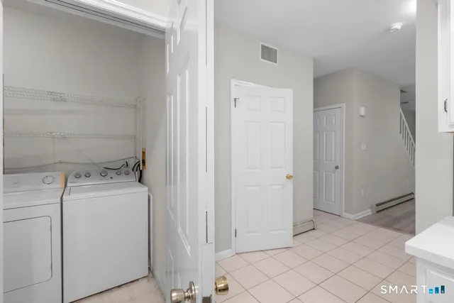 a view of a storage & utility room with dryer and washer