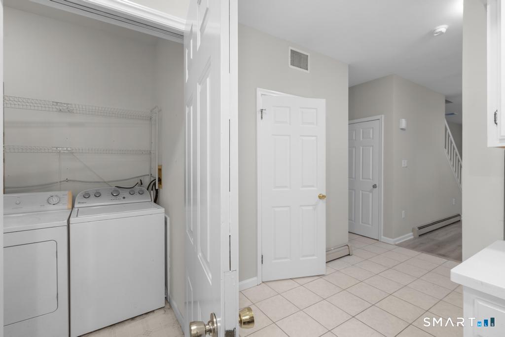 815 South Pine Creek Road Fairfield, CT 06824 - Photo 8 of 32 a view of a storage & utility room with dryer and washer