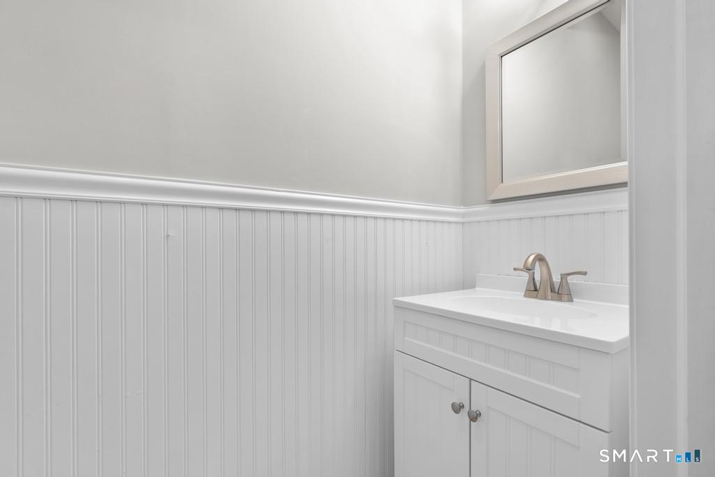 815 South Pine Creek Road Fairfield, CT 06824 - Photo 10 of 32 a bathroom with a sink and a mirror