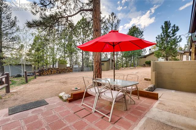 91 Alpine Road Woodland Park, CO 80863 - Photo 5 of 36 Yard is partly fenced with split-rail. Property includes 2 storage sheds.