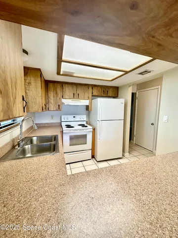 a kitchen with stainless steel appliances a refrigerator and a sink