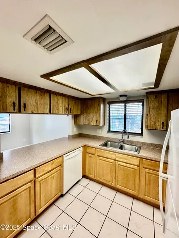 a kitchen with cabinets a sink and appliances