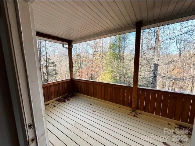 a view of a room with wooden floor and a window