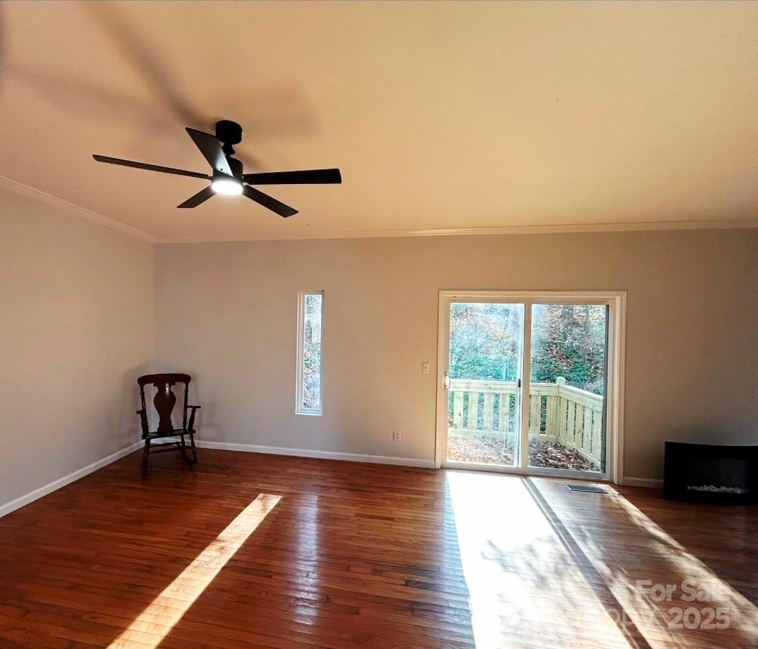 178 Levi Road Columbus, NC 28722 - Photo 21 of 36 a view of empty room with wooden floor and fan