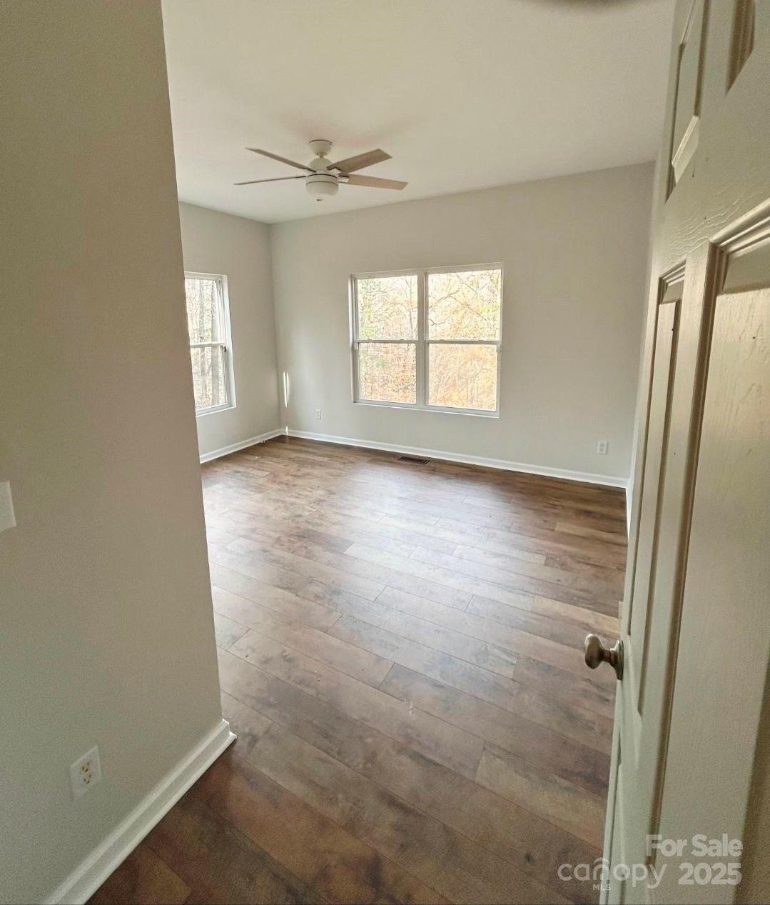 178 Levi Road Columbus, NC 28722 - Photo 23 of 36 an empty room with wooden floor and windows