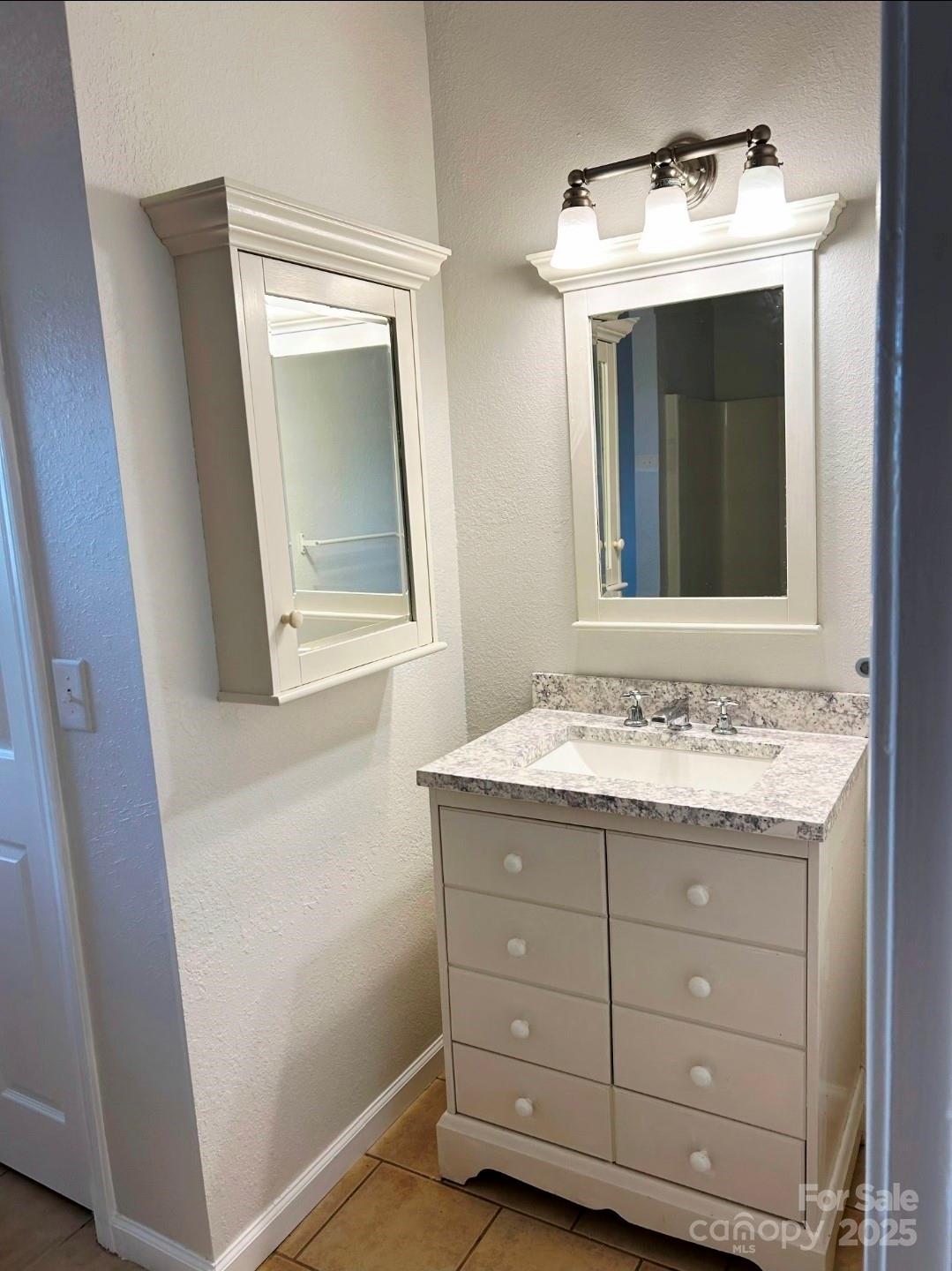 178 Levi Road Columbus, NC 28722 - Photo 35 of 36 a bathroom with a granite countertop sink and a mirror