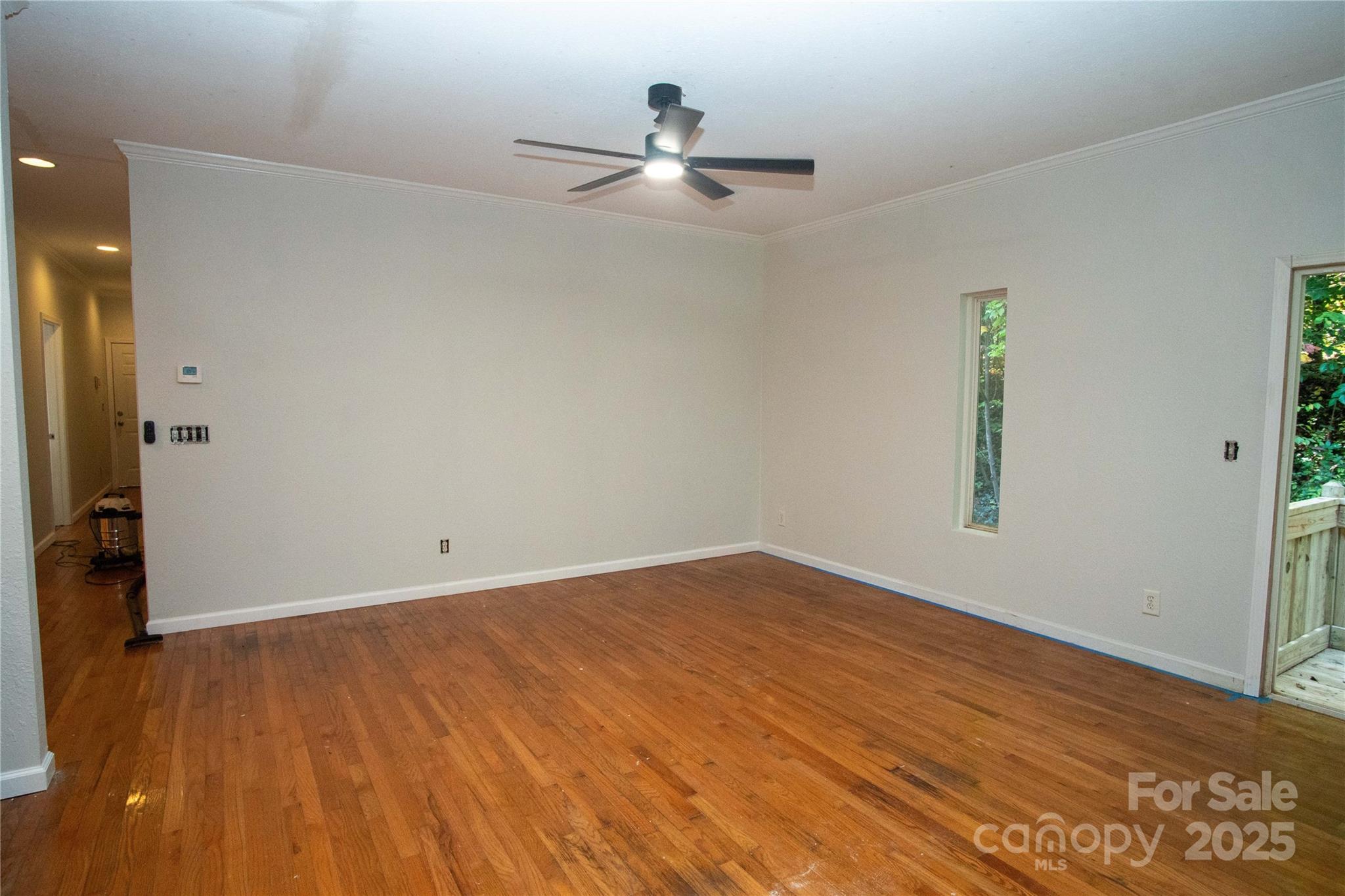 178 Levi Road Columbus, NC 28722 - Photo 9 of 36 an empty room with wooden floor and windows