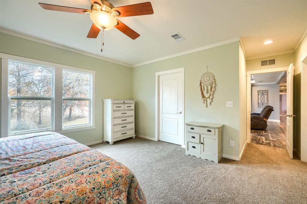 575 Highway 276 Point, TX 75472 - Photo 13 of 32 a bedroom with a bed and a chandelier