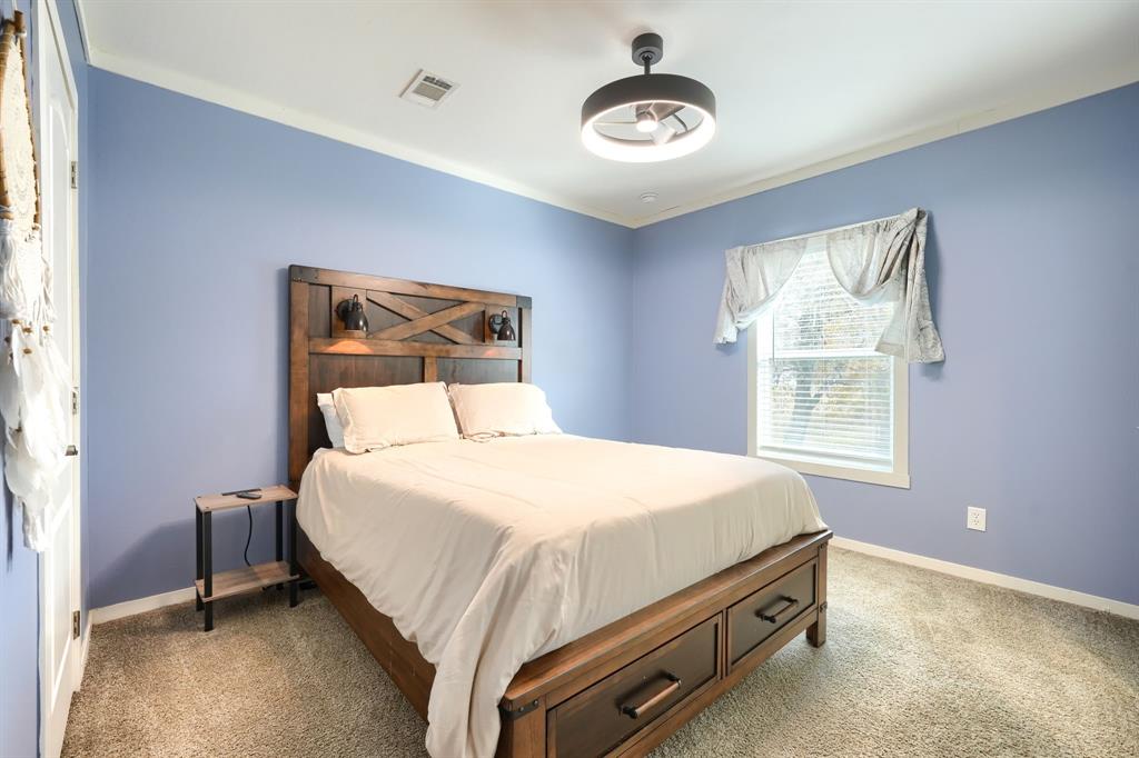 575 Highway 276 Point, TX 75472 - Photo 20 of 32 a bedroom with a bed and a chandelier