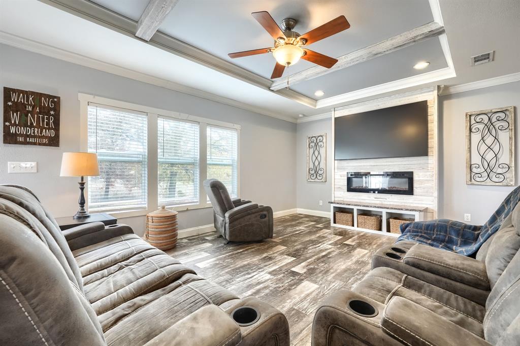 575 Highway 276 Point, TX 75472 - Photo 2 of 32 a living room with furniture a flat screen tv and a large window