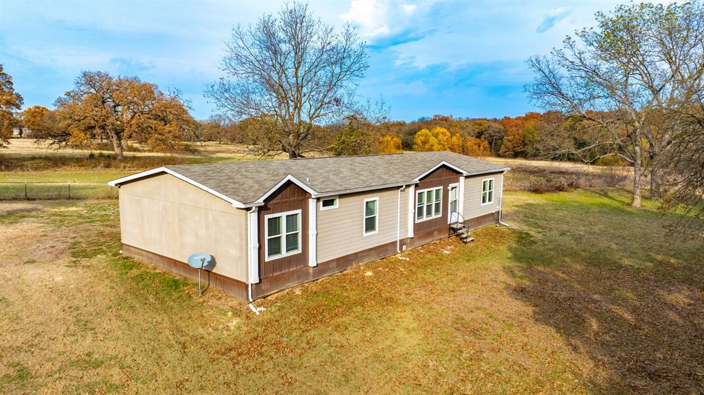 575 Highway 276 Point, TX 75472 - Photo 24 of 32 a view of a large house with a big yard and large trees
