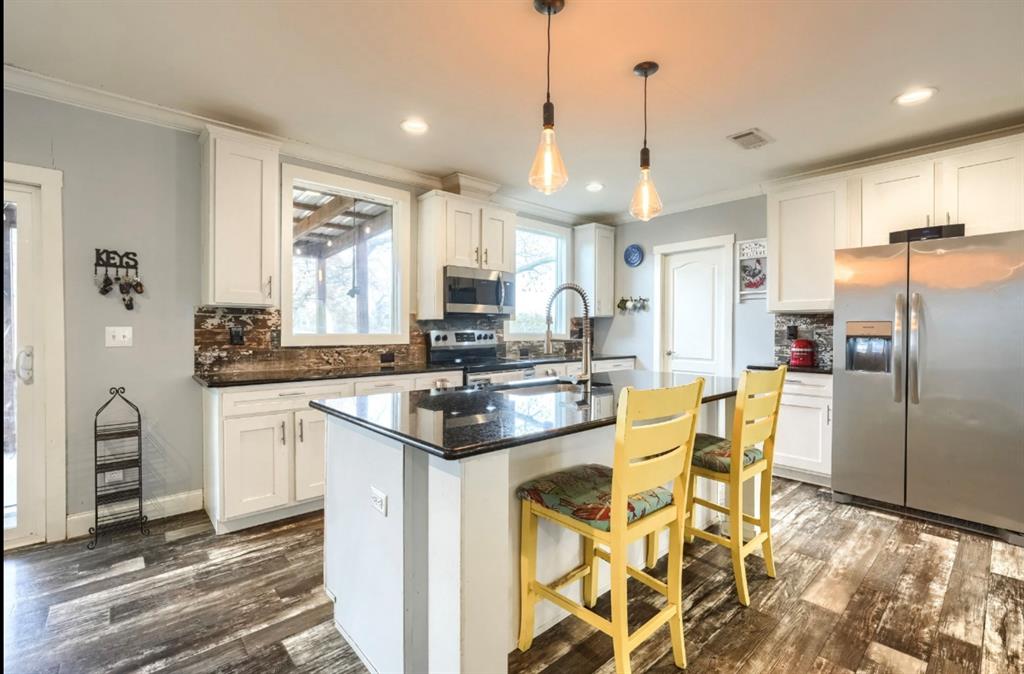575 Highway 276 Point, TX 75472 - Photo 7 of 32 a kitchen with stainless steel appliances kitchen island granite countertop a sink and cabinets
