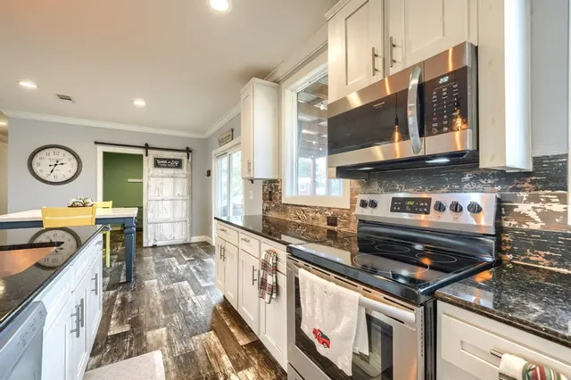 a kitchen with stainless steel appliances granite countertop a stove and a sink
