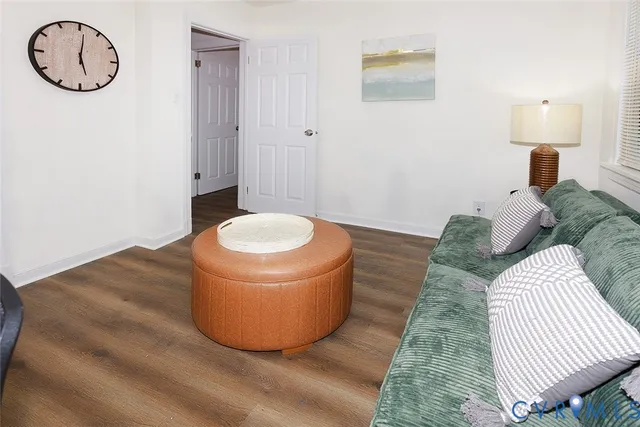 a view of a room with wooden floor and ceiling fan
