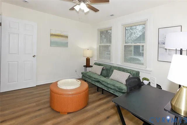 a view of a room with wooden floor and white walls