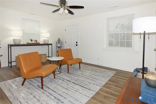 a dining room with table chairs and a wooden floor