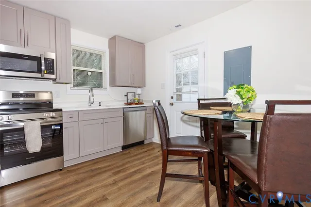 a view of a dining room with furniture and wooden floor