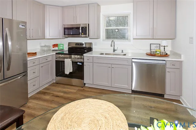 a kitchen with stainless steel appliances a refrigerator stove and sink
