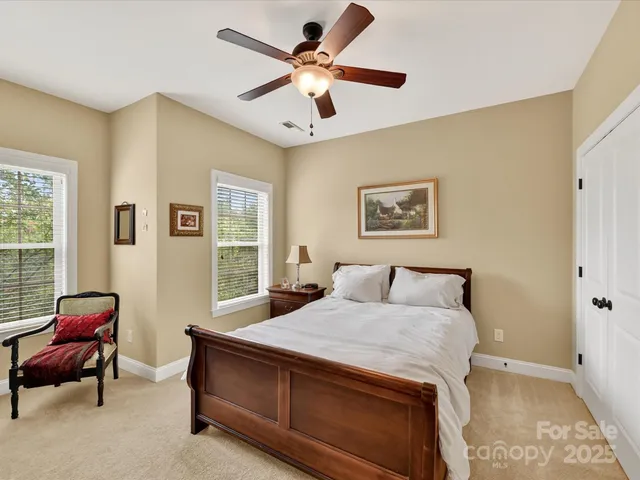 a bedroom with a bed couch and window