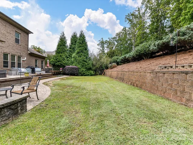 a view of a backyard with swimming pool