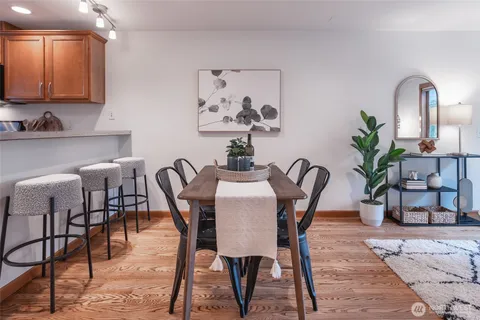 a dining room with furniture and wooden floor