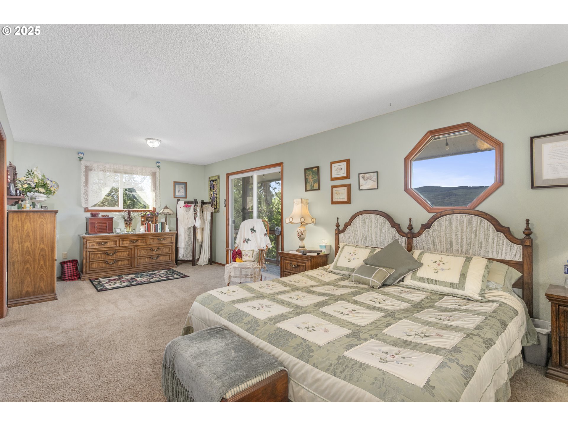 36589 Alder Branch Road Springfield, OR 97478 - Photo 20 of 36 a bedroom with a large bed and a chandelier