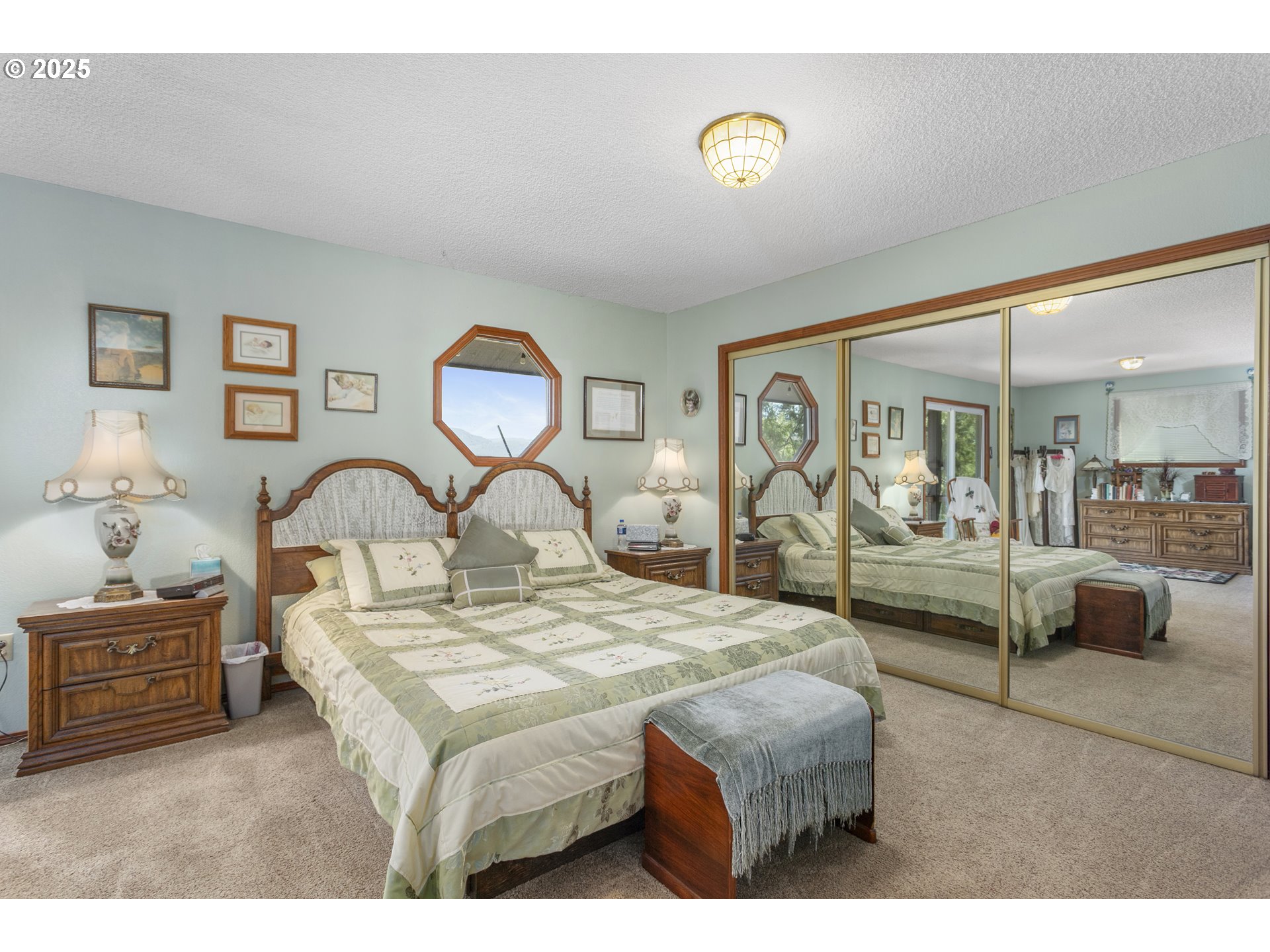 36589 Alder Branch Road Springfield, OR 97478 - Photo 21 of 36 a bedroom with a large bed and a chandelier