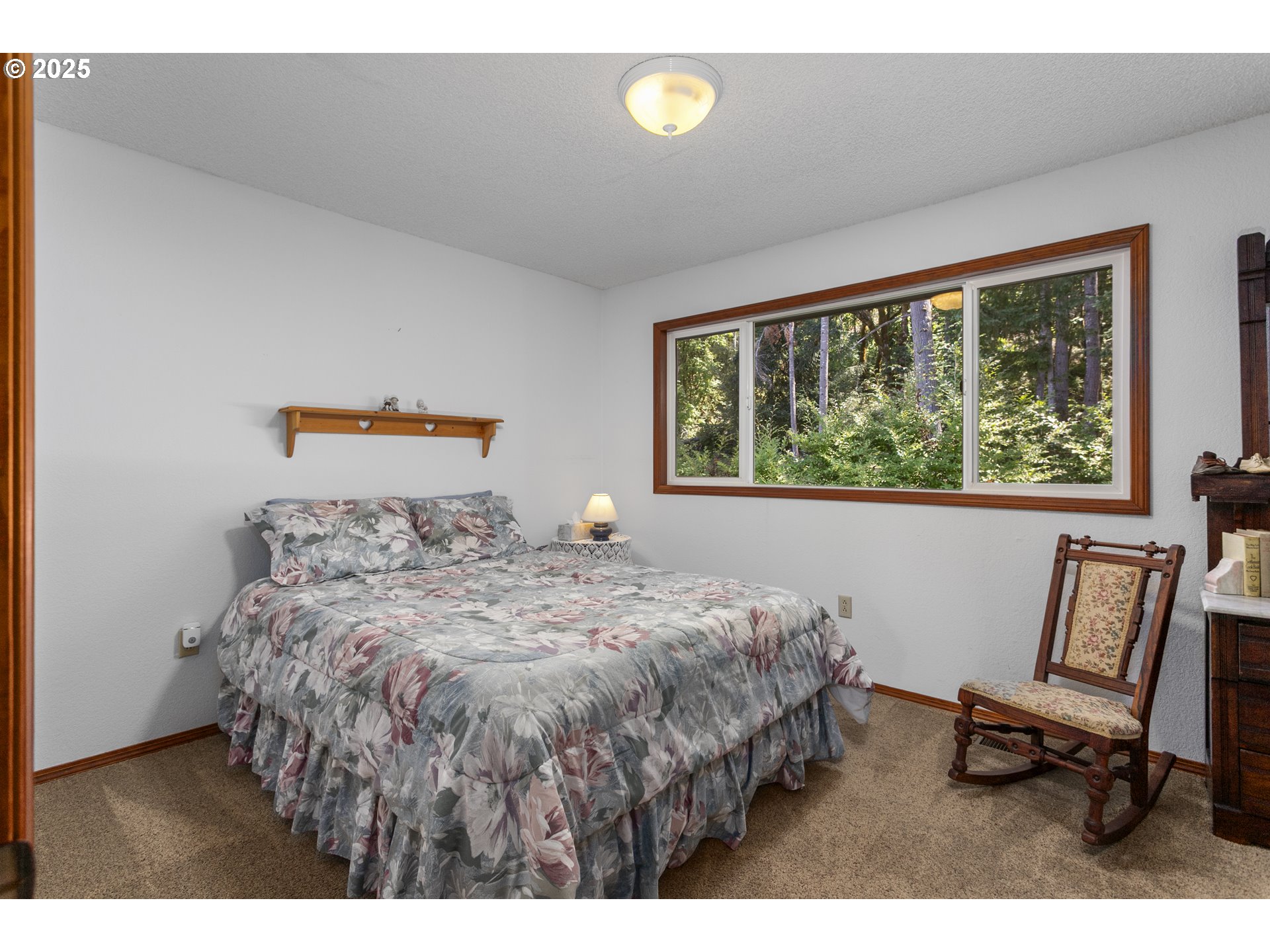 36589 Alder Branch Road Springfield, OR 97478 - Photo 23 of 36 a bedroom with a bed a chair and a large window