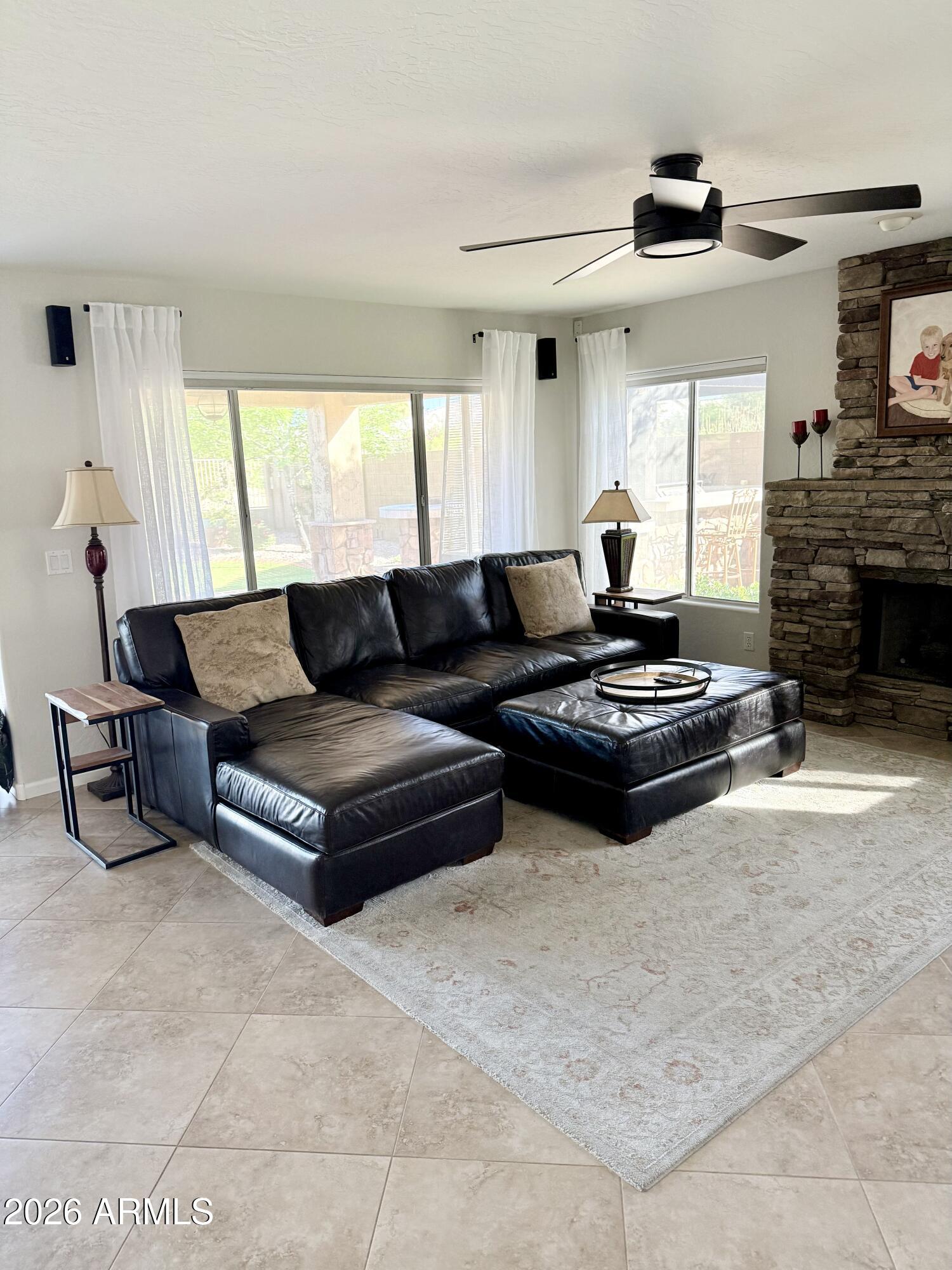 3426 East Clark Road Phoenix, AZ 85050 - Photo 5 of 48 a living room with furniture a fireplace and a flat screen tv