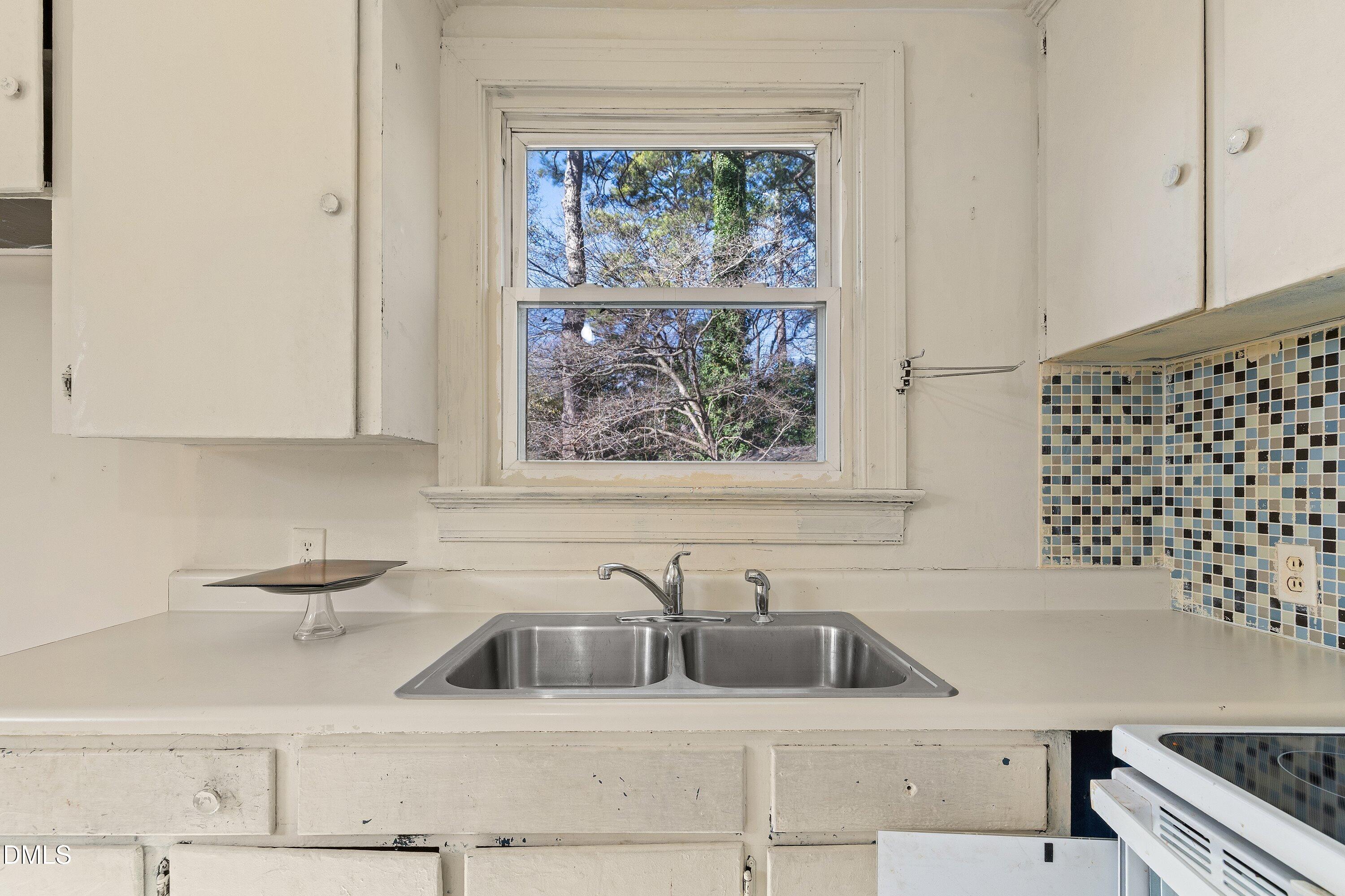 1205 Watauga Street Raleigh, NC 27604 - Photo 11 of 26 a kitchen with a sink cabinets and a window