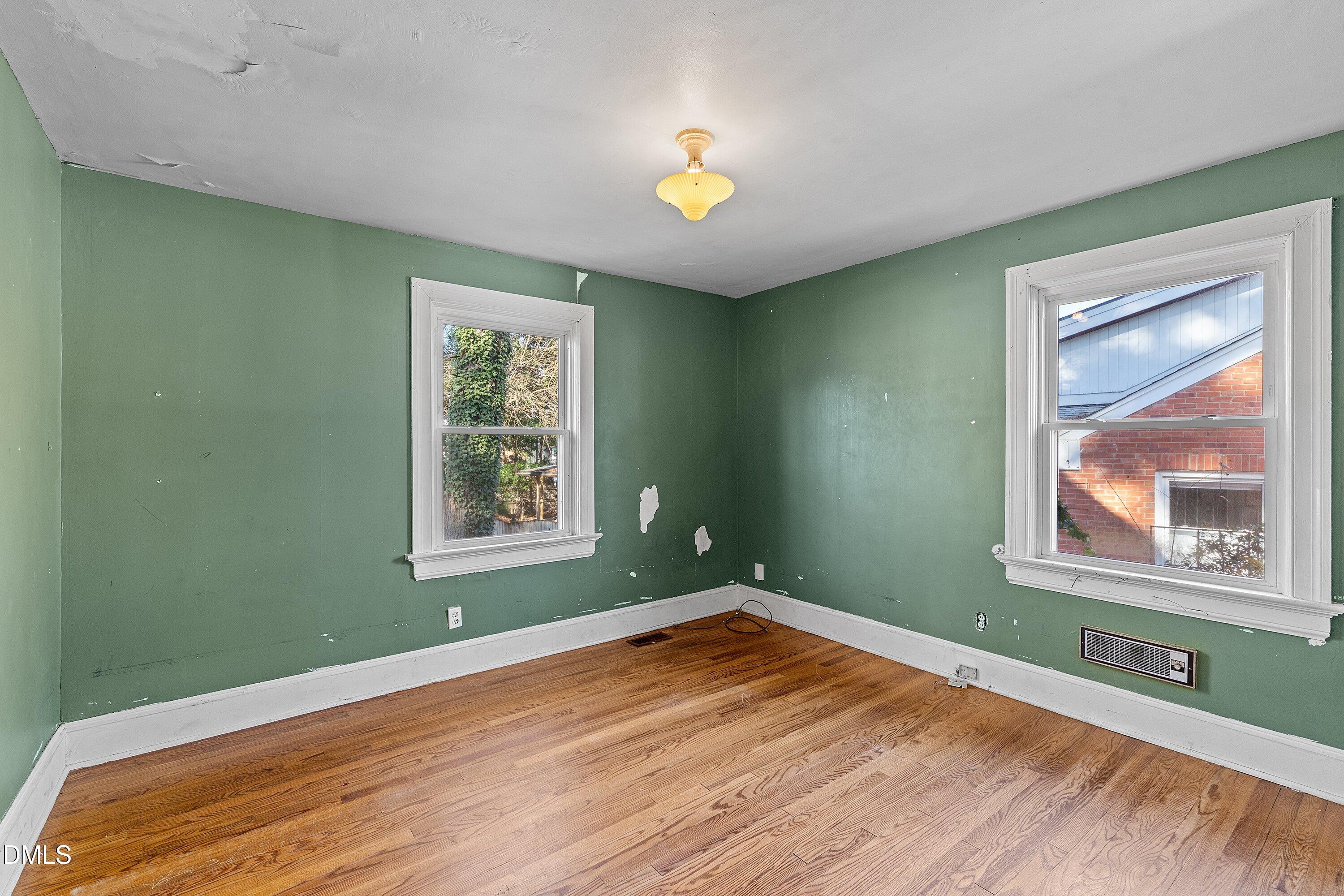 1205 Watauga Street Raleigh, NC 27604 - Photo 14 of 26 a view of an empty room with wooden floor and a window