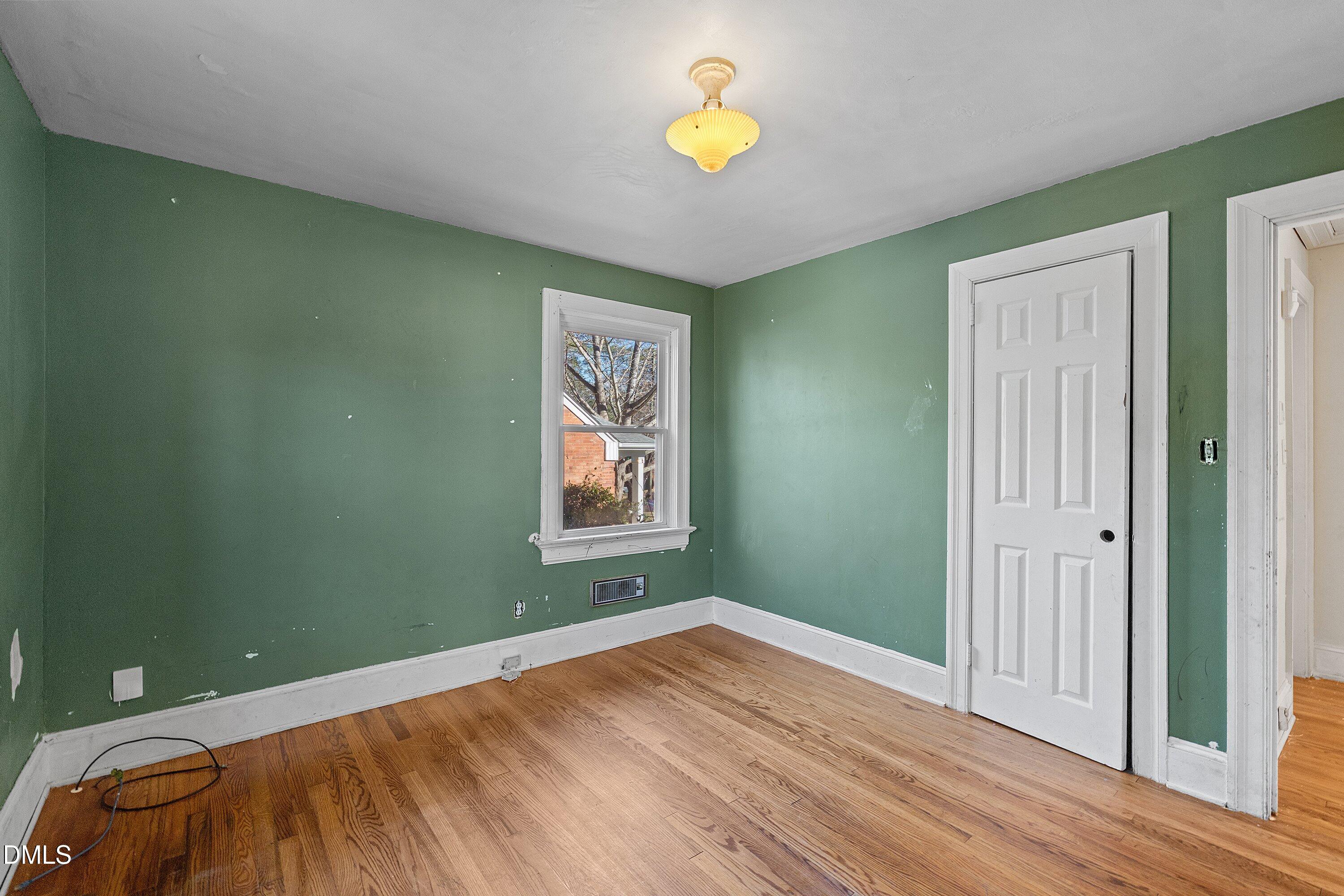 1205 Watauga Street Raleigh, NC 27604 - Photo 15 of 26 a view of a room with a wooden floor and a window