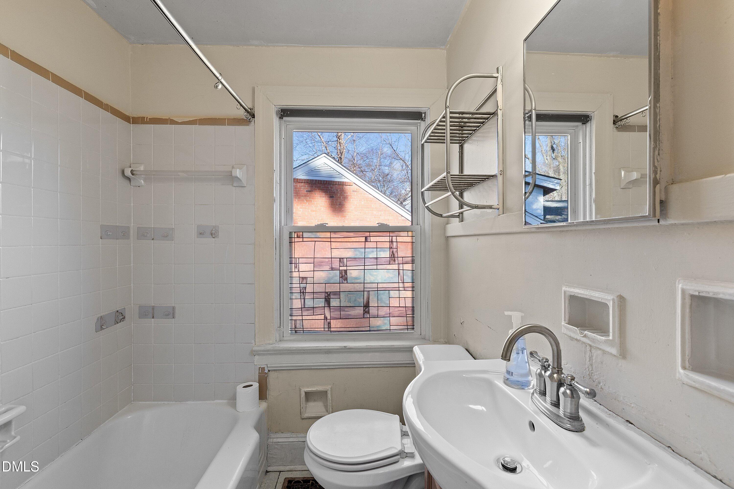 1205 Watauga Street Raleigh, NC 27604 - Photo 16 of 26 a bathroom with a sink a toilet and a bathtub