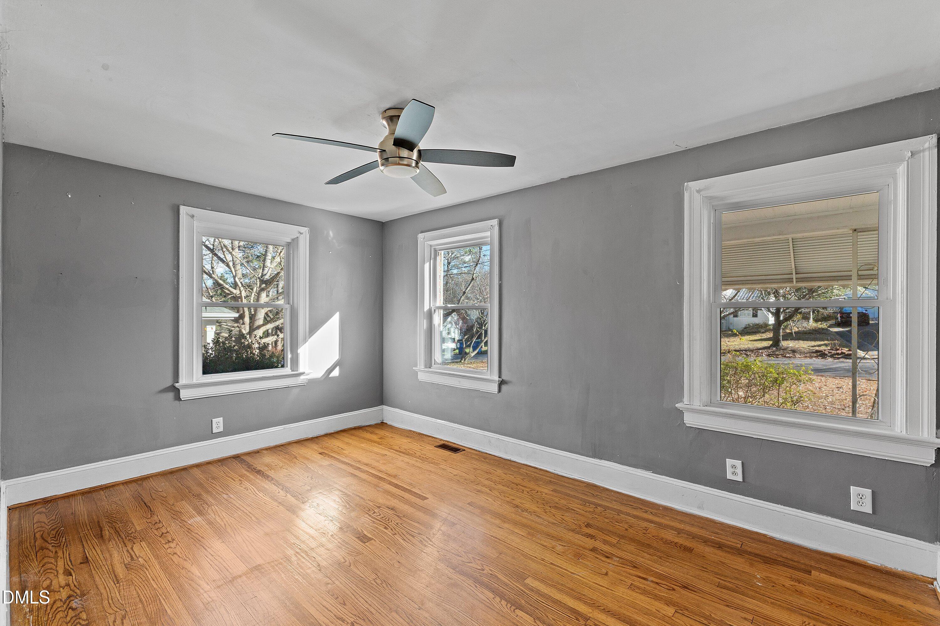 1205 Watauga Street Raleigh, NC 27604 - Photo 17 of 26 a view of an empty room with window and wooden floor