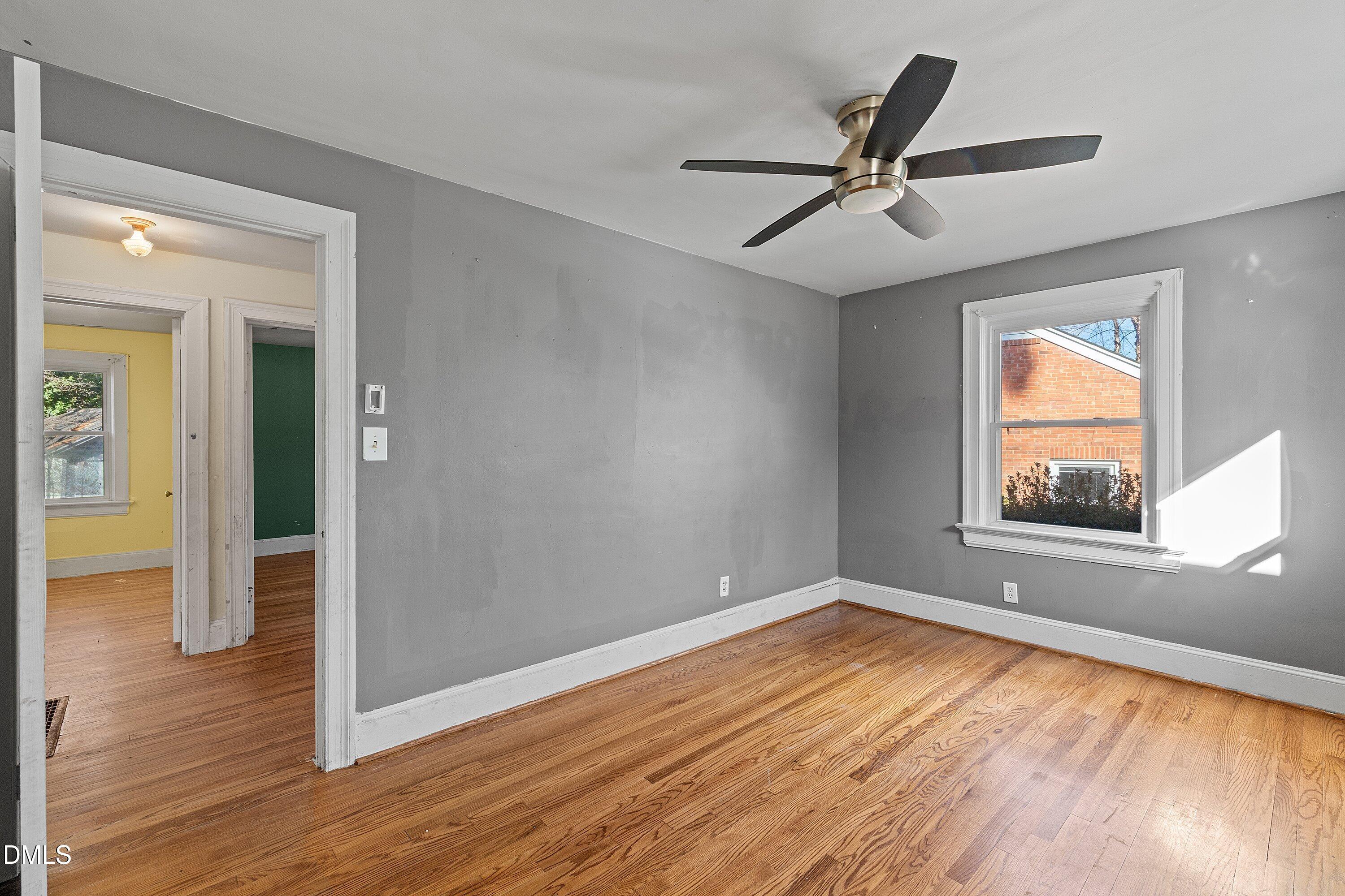 1205 Watauga Street Raleigh, NC 27604 - Photo 18 of 26 wooden floor in an empty room with a window