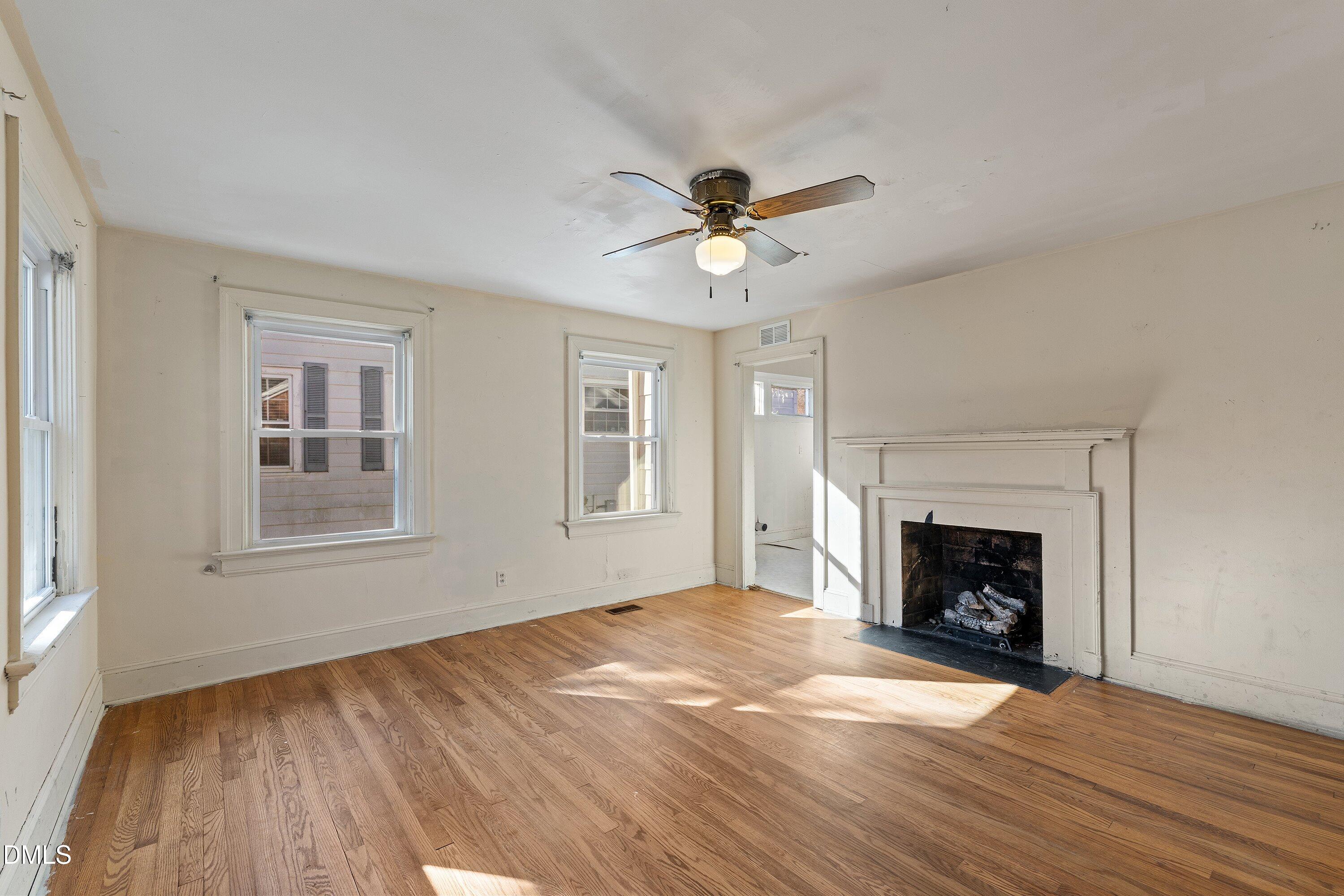 1205 Watauga Street Raleigh, NC 27604 - Photo 3 of 26 wooden floor fireplace and windows in an empty room