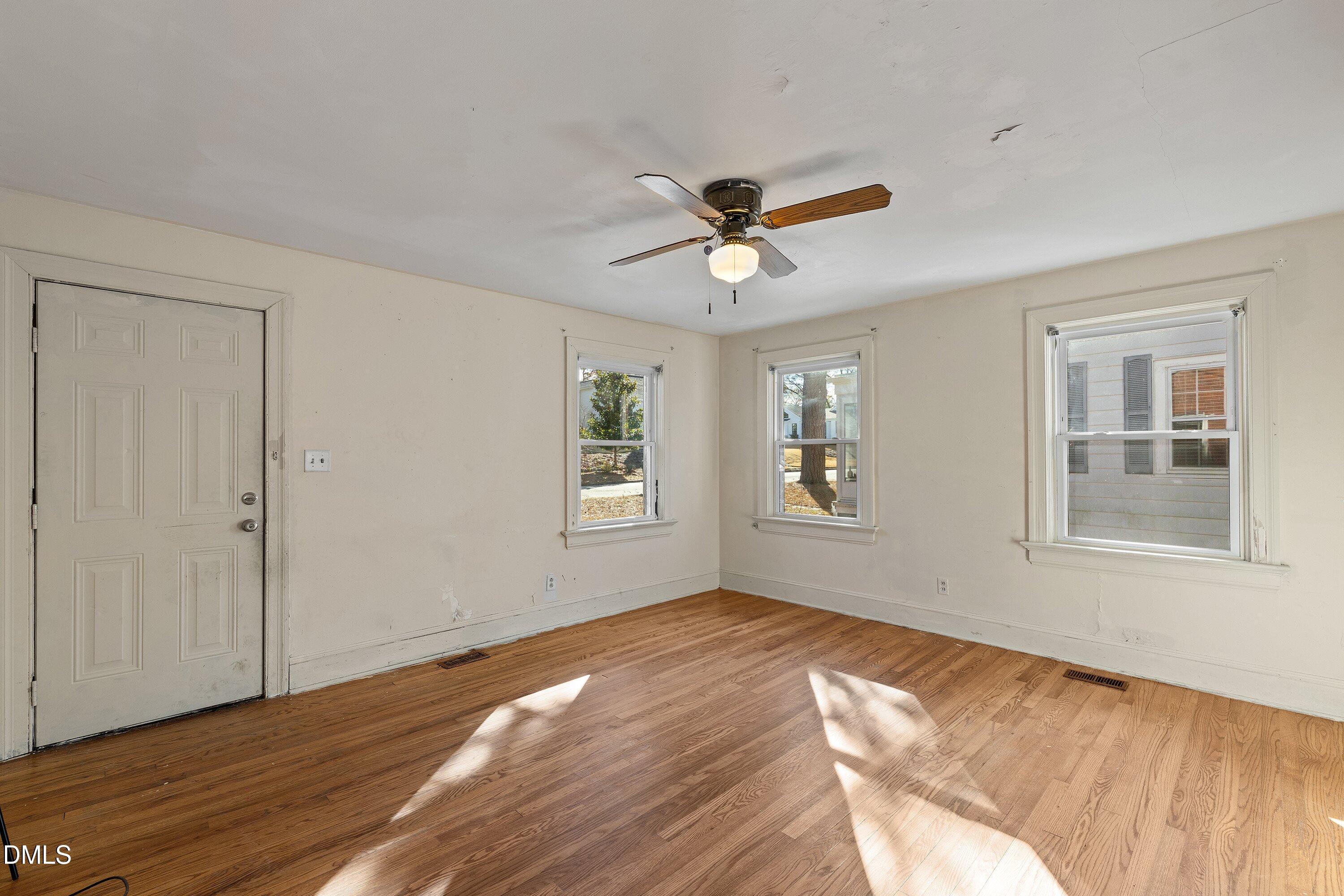 1205 Watauga Street Raleigh, NC 27604 - Photo 5 of 26 a view of empty room with wooden floor and fan