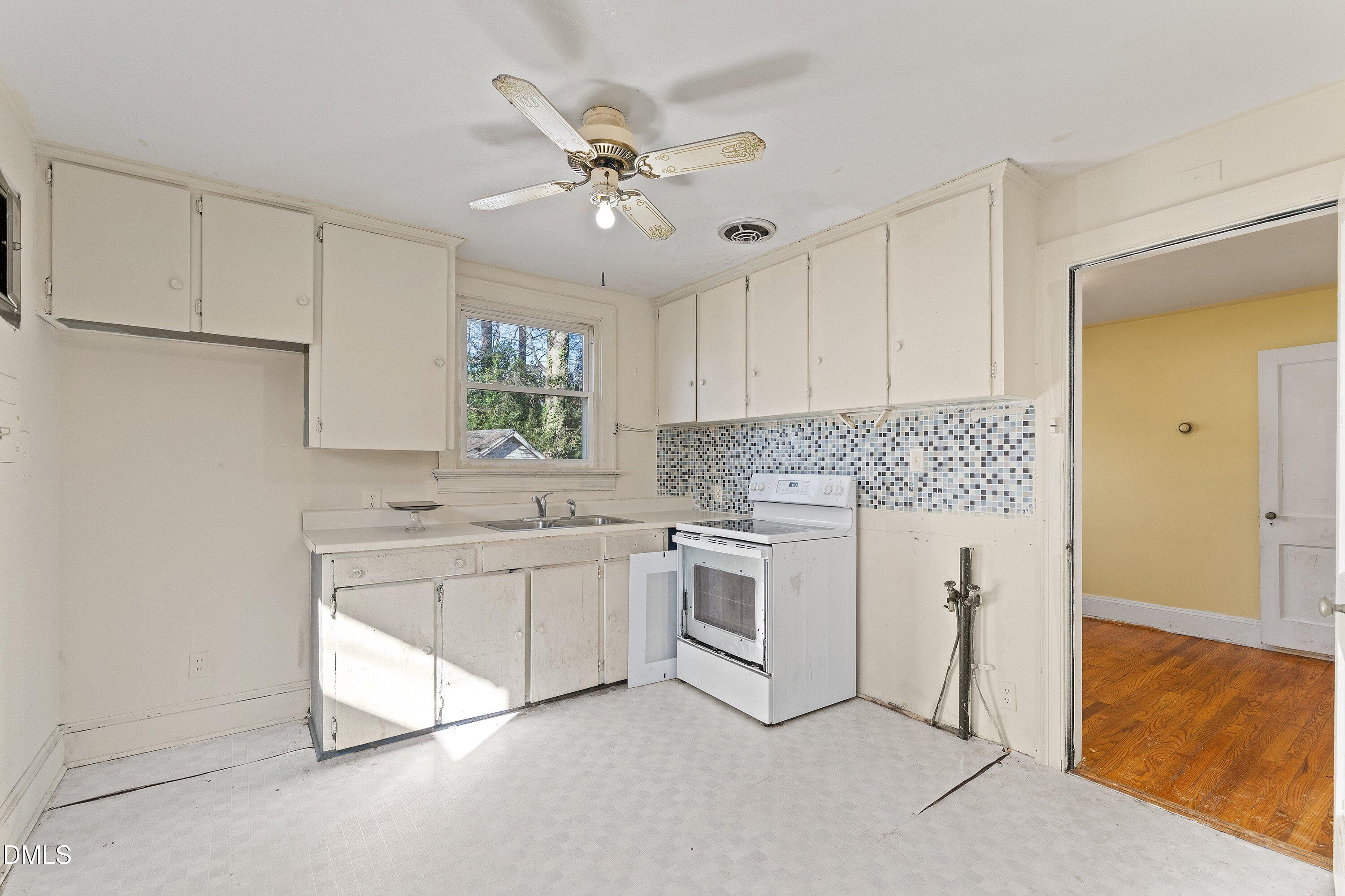 1205 Watauga Street Raleigh, NC 27604 - Photo 7 of 26 a kitchen with white cabinets and white appliances