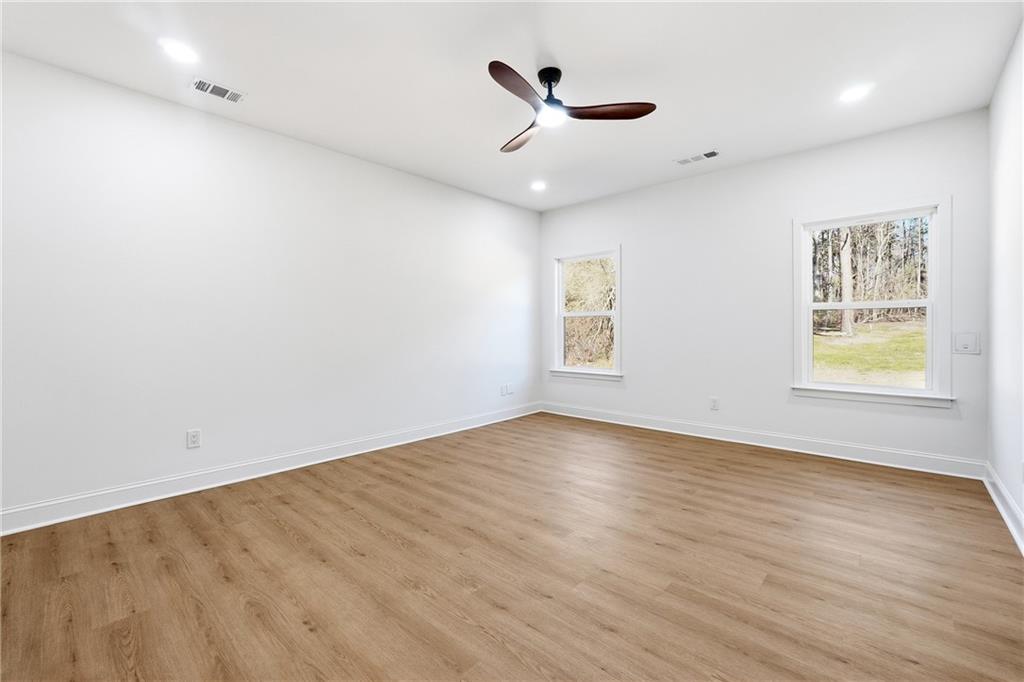 644 Hampton Road Hampton, GA 30228 - Photo 20 of 40 an empty room with wooden floor and windows