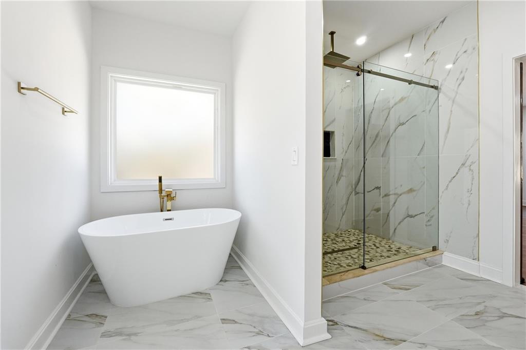 644 Hampton Road Hampton, GA 30228 - Photo 26 of 40 a bathroom with a bathtub and shower